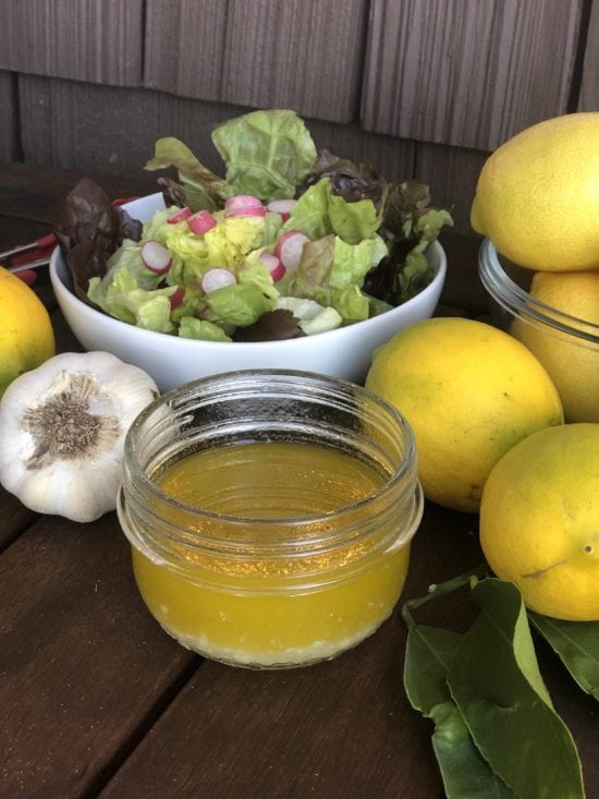 curry house salad dressing with garlic and lemons featured along side lettuce