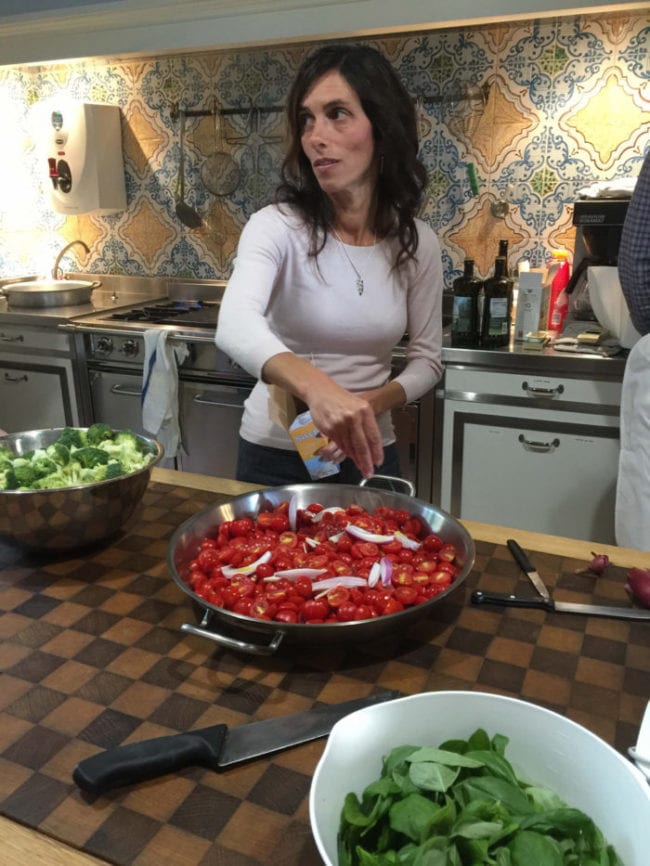 carla cooking tomatoes in kitchen