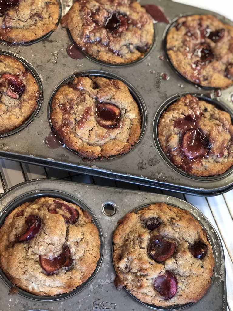 cherry muffins in metal baking tins
