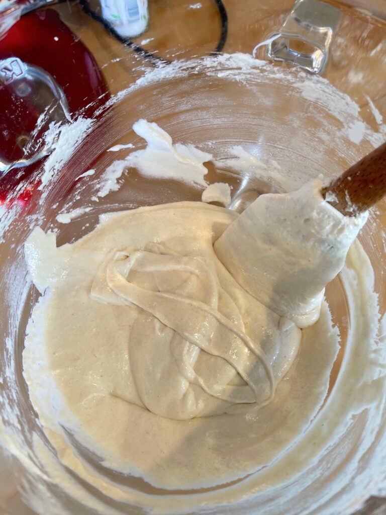 mixing almond flour in glass bowl for french macarons